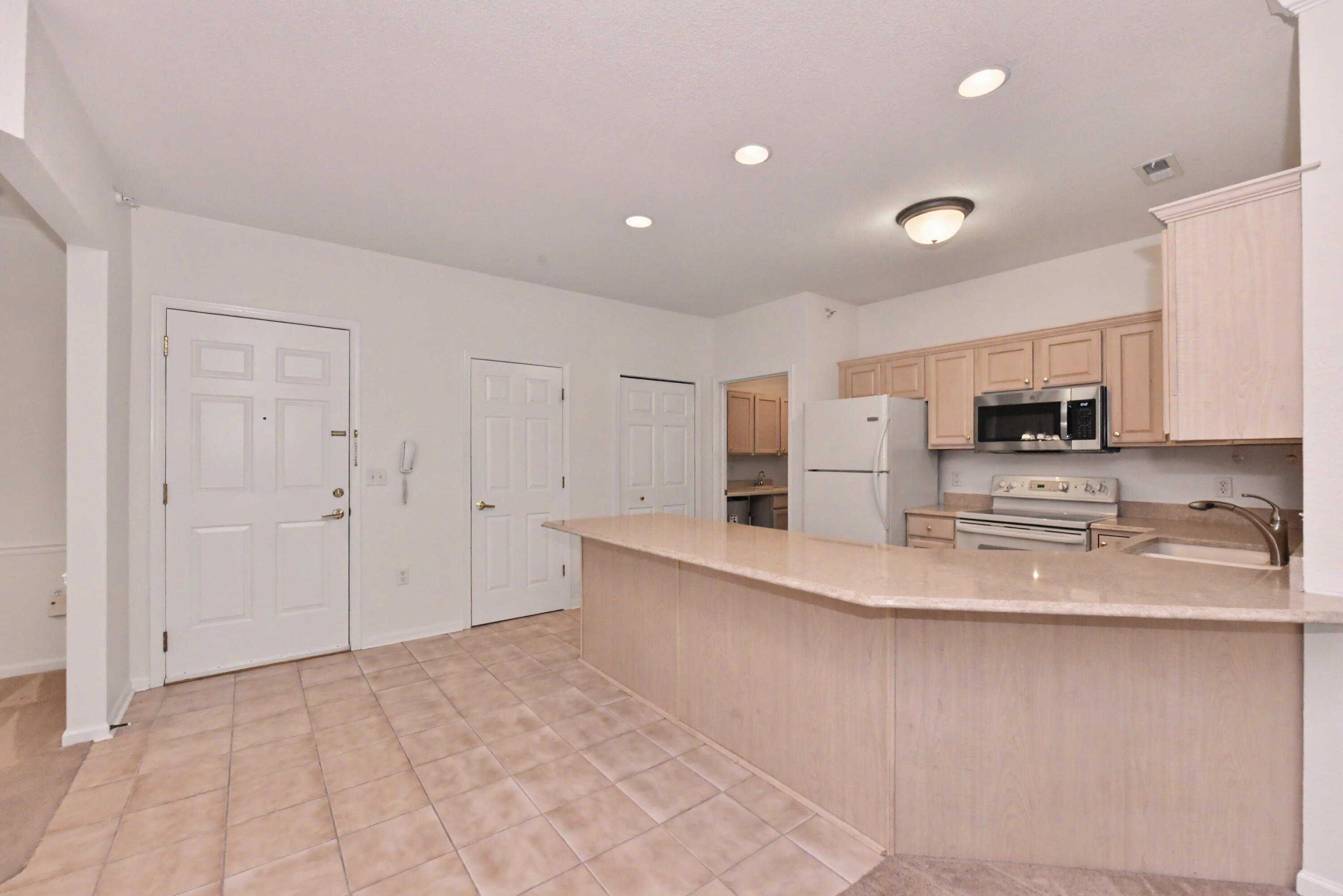 13050 West Bluemound Road, Unit 203 Elm Grove, WI 53122 - Photo 3 of 24 Bright streamlined kitchen with breakfast counter