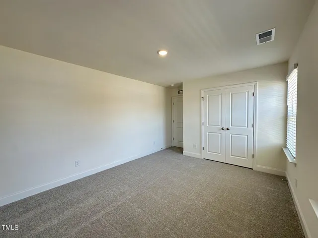 an empty room with a empty space and windows