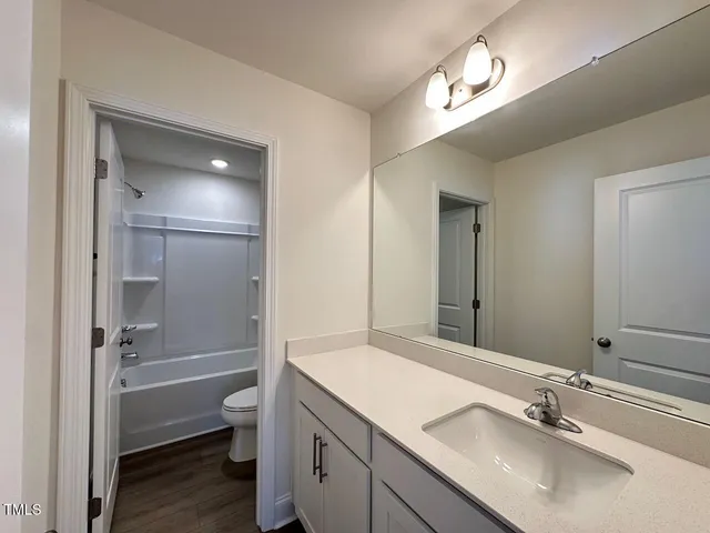 a view of a refrigerator in kitchen and a windows