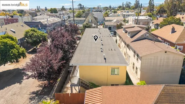 an aerial view of a house with a yard