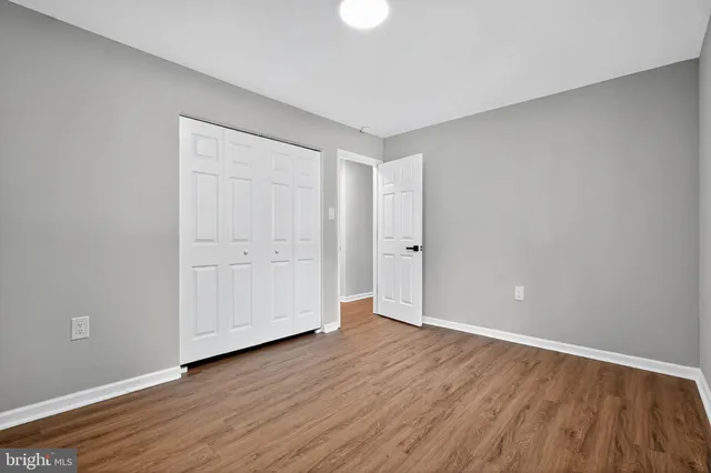 a view of an empty room and wooden floor