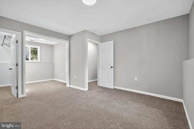 a view of an empty room and closet area