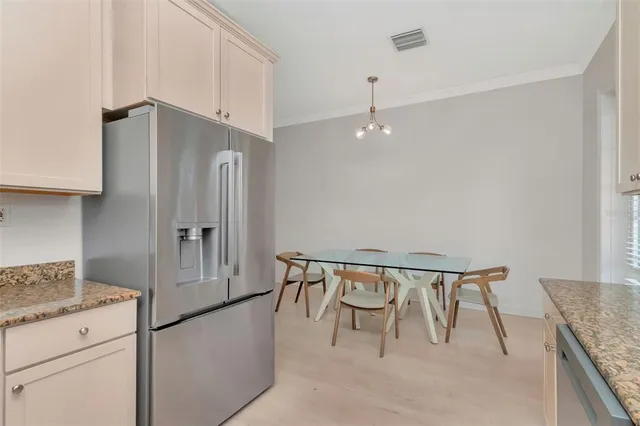 a kitchen with granite countertop white cabinets and a sink