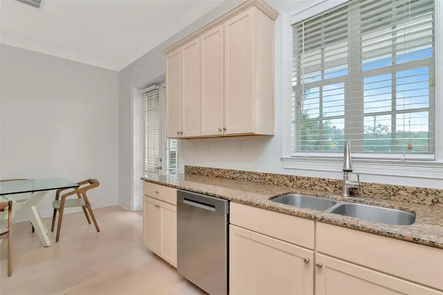 a kitchen with stainless steel appliances granite countertop a refrigerator stove and cabinets