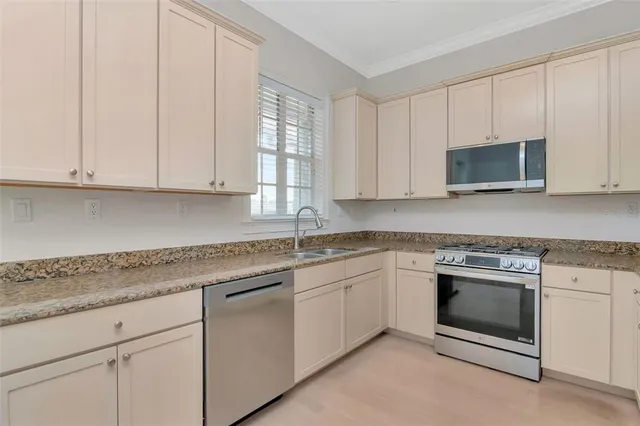 a bathroom with a granite countertop sink a toilet and a mirror