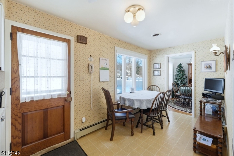 47 Clinton Avenue New Providence, NJ 07974 - Photo 11 of 43 a view of a dining room with furniture and a window