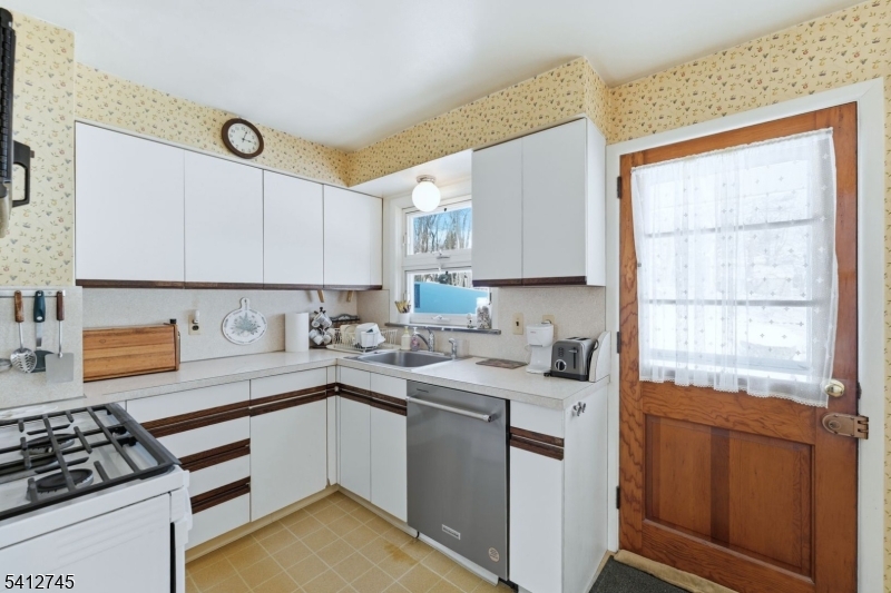 47 Clinton Avenue New Providence, NJ 07974 - Photo 12 of 43 a kitchen with a sink stove and cabinets