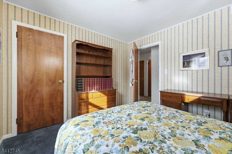 47 Clinton Avenue New Providence, NJ 07974 - Photo 19 of 43 a bedroom with a bed and a dresser