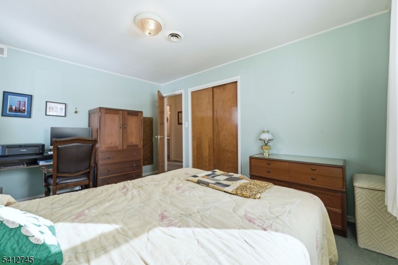 47 Clinton Avenue New Providence, NJ 07974 - Photo 22 of 43 a bedroom with a bed and furniture