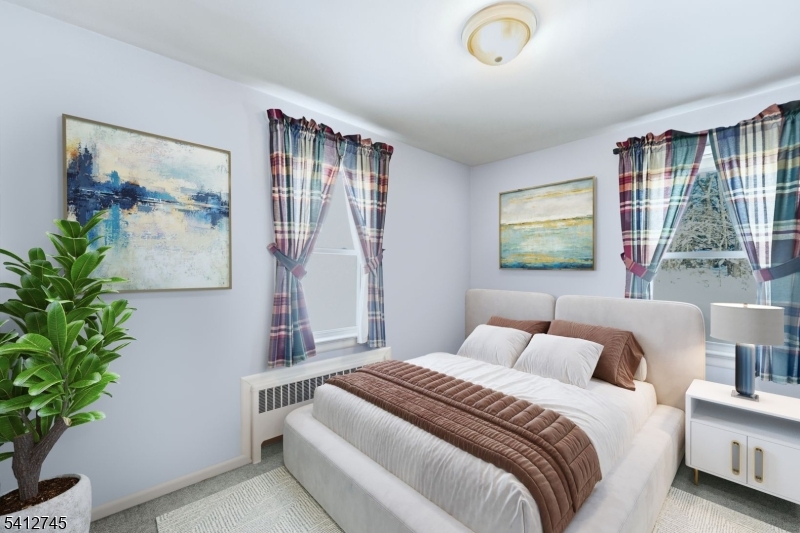 47 Clinton Avenue New Providence, NJ 07974 - Photo 23 of 43 a bedroom with a large bed and a potted plant