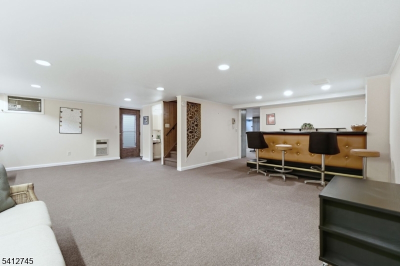 47 Clinton Avenue New Providence, NJ 07974 - Photo 27 of 43 a view of an empty room with furniture and a ceiling fan