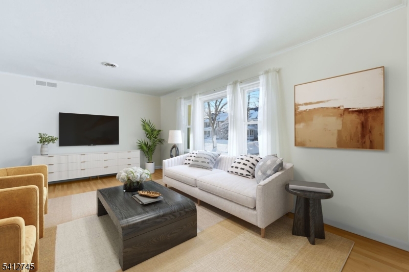 47 Clinton Avenue New Providence, NJ 07974 - Photo 3 of 43 a living room with furniture and a flat screen tv