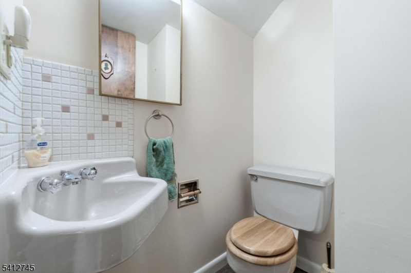 47 Clinton Avenue New Providence, NJ 07974 - Photo 31 of 43 a bathroom with a toilet a sink and mirror