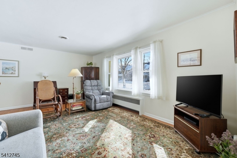 47 Clinton Avenue New Providence, NJ 07974 - Photo 4 of 43 a living room with furniture and a flat screen tv