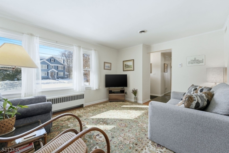 47 Clinton Avenue New Providence, NJ 07974 - Photo 5 of 43 a living room with furniture and a flat screen tv