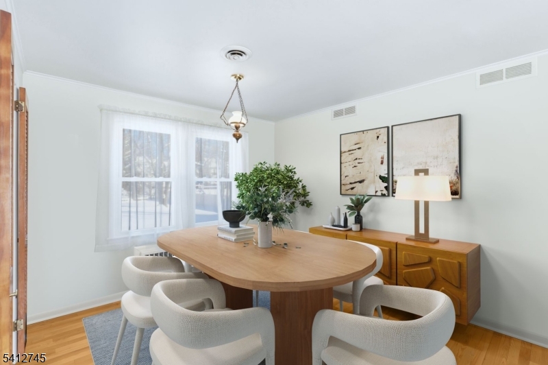 47 Clinton Avenue New Providence, NJ 07974 - Photo 7 of 43 a dining room with furniture a window and wooden floor