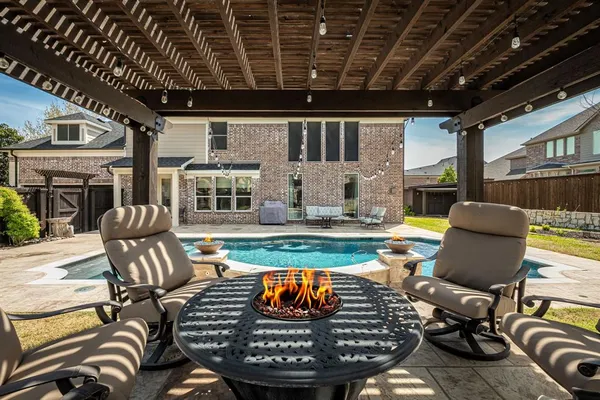 a view of a dining room with furniture a chandelier and wooden floor