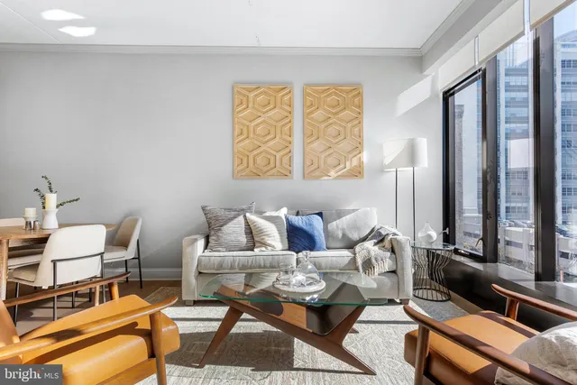 a living room with furniture and a floor to ceiling window