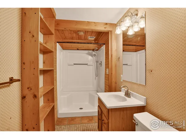 a bathroom with a sink a mirror and shower