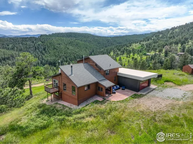 an aerial view of a house with garden space and street view