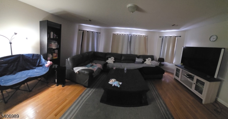 26 Clinton Place Newark, NJ 07108 - Photo 12 of 18 a living room with furniture and a flat screen tv