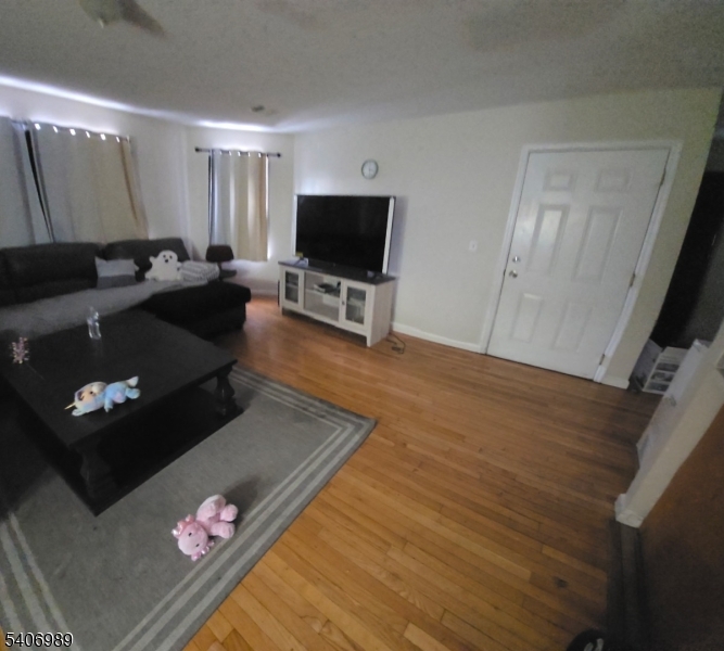 26 Clinton Place Newark, NJ 07108 - Photo 13 of 18 a living room with furniture and a flat screen tv