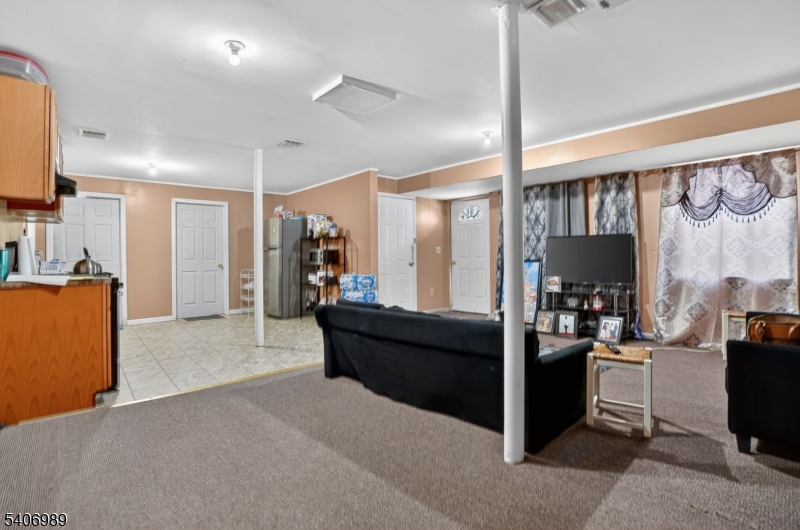 26 Clinton Place Newark, NJ 07108 - Photo 3 of 18 a living room with furniture and a flat screen tv
