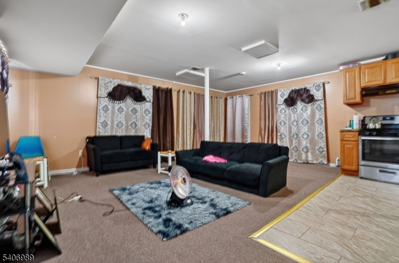 26 Clinton Place Newark, NJ 07108 - Photo 7 of 18 a living room with furniture and a flat screen tv