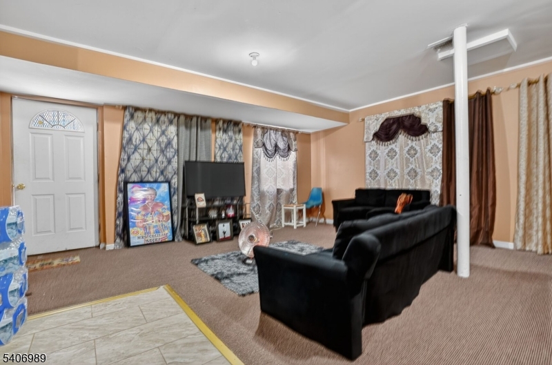 26 Clinton Place Newark, NJ 07108 - Photo 8 of 18 a living room with furniture and a fireplace