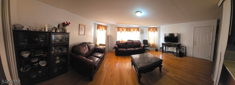 26 Clinton Place Newark, NJ 07108 - Photo 10 of 18 a living room with furniture and a flat screen tv