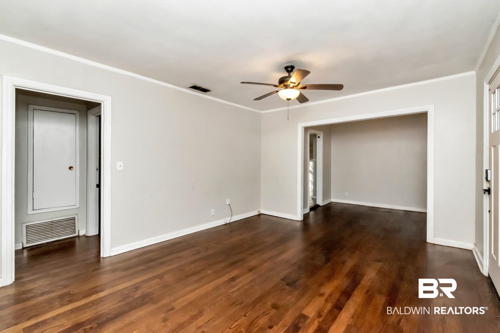 5001 Hillwood Circle South Mobile, AL 36608 - Photo 8 of 20 Unfurnished room featuring dark wood finished floors, visible vents, and crown molding