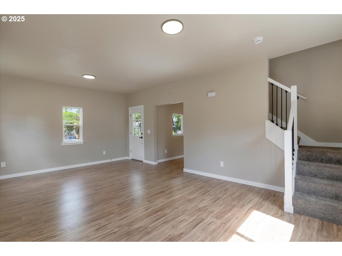 494 17th Street Northeast Salem, OR 97301 - Photo 11 of 44 a view of an empty room with wooden floor and a window