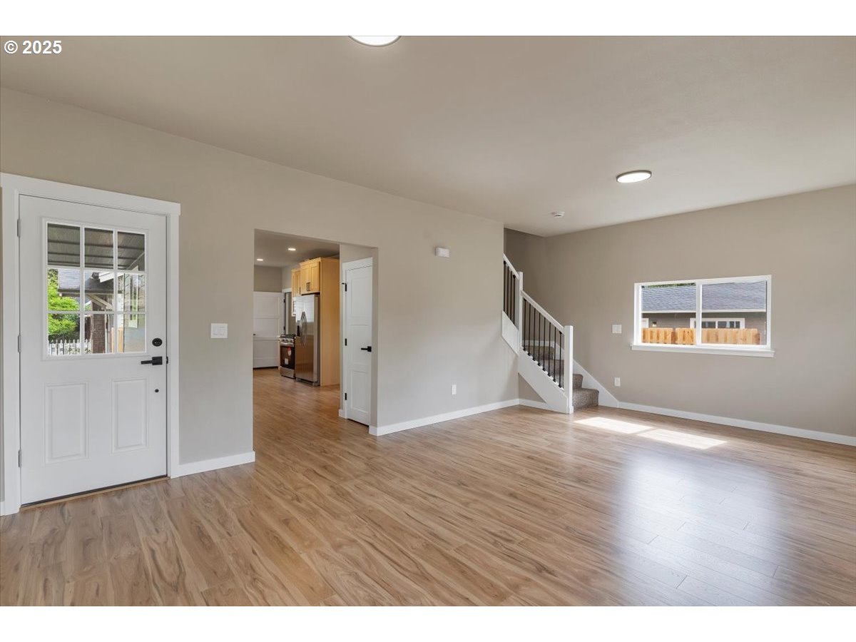 494 17th Street Northeast Salem, OR 97301 - Photo 14 of 44 a view of an empty room with wooden floor and a window
