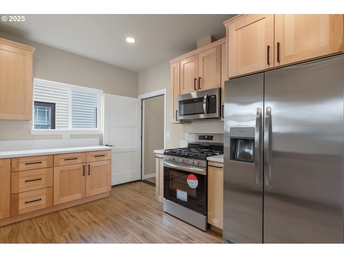 494 17th Street Northeast Salem, OR 97301 - Photo 16 of 44 a kitchen with stainless steel appliances granite countertop a refrigerator a sink dishwasher a stove and a refrigerator