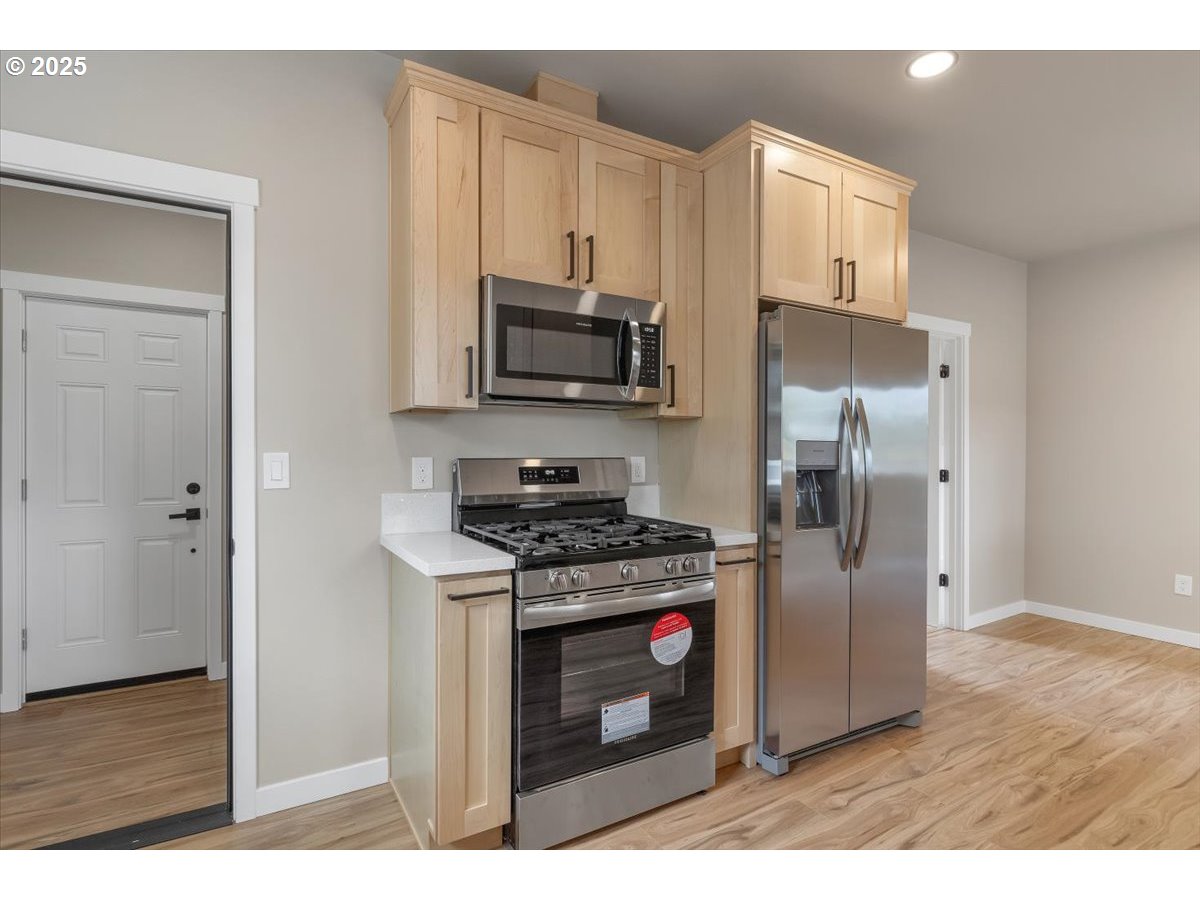494 17th Street Northeast Salem, OR 97301 - Photo 22 of 44 a kitchen with stainless steel appliances granite countertop a stove a refrigerator and a microwave