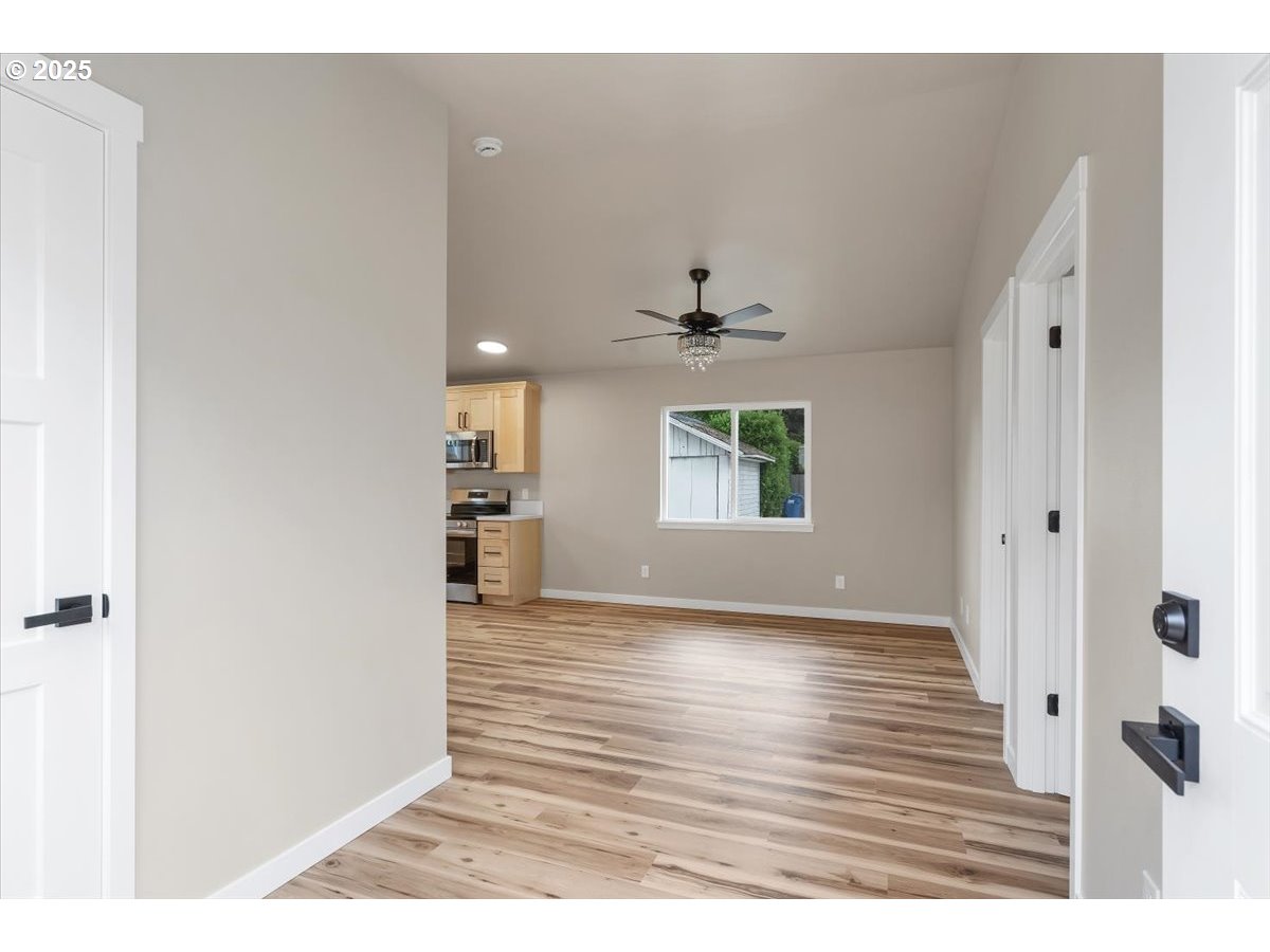 494 17th Street Northeast Salem, OR 97301 - Photo 31 of 44 a view of an empty room with window and wooden floor