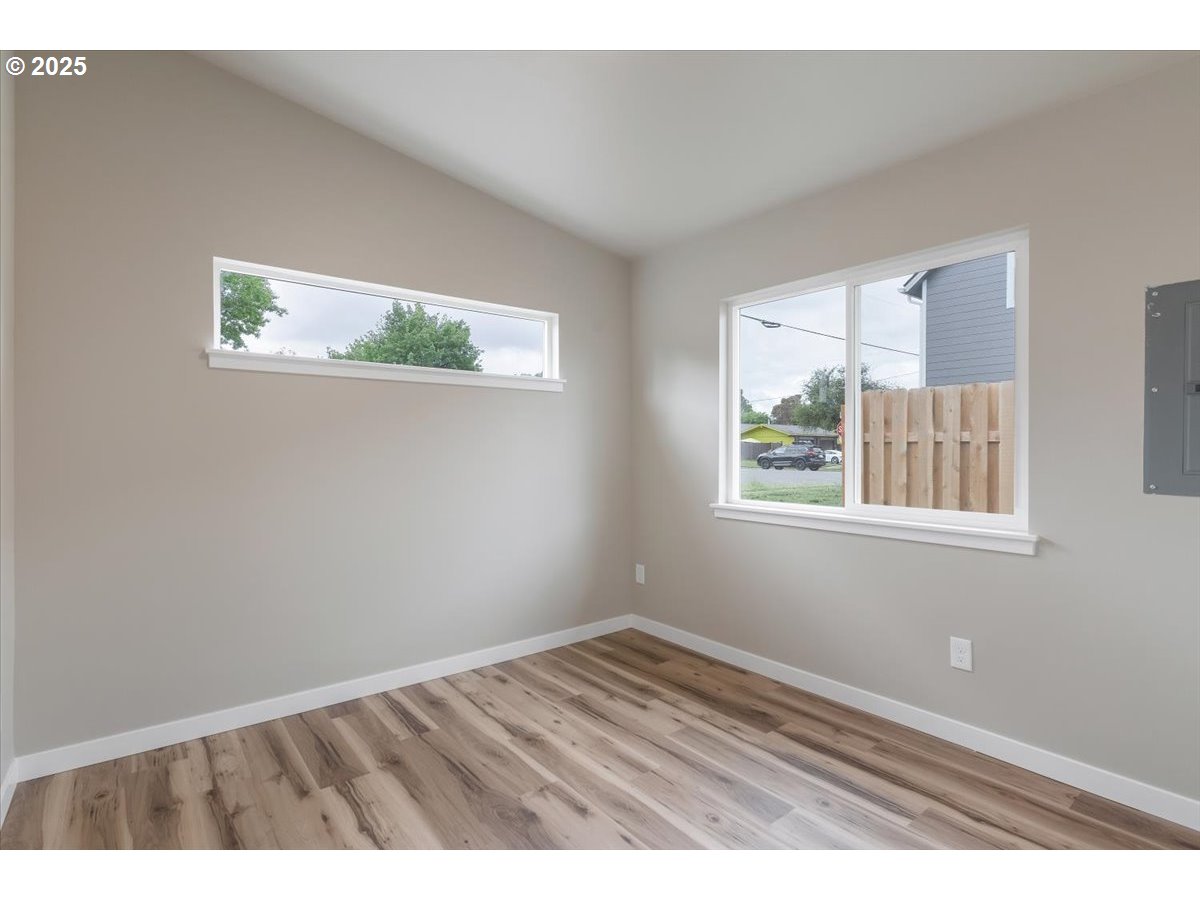 494 17th Street Northeast Salem, OR 97301 - Photo 35 of 44 an empty room with wooden floor and windows