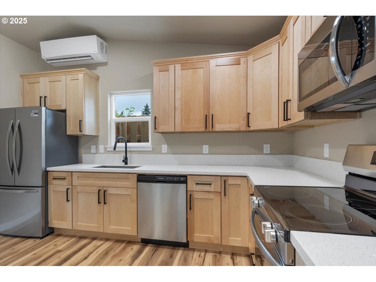 494 17th Street Northeast Salem, OR 97301 - Photo 40 of 44 a kitchen with stainless steel appliances granite countertop a sink stove and refrigerator