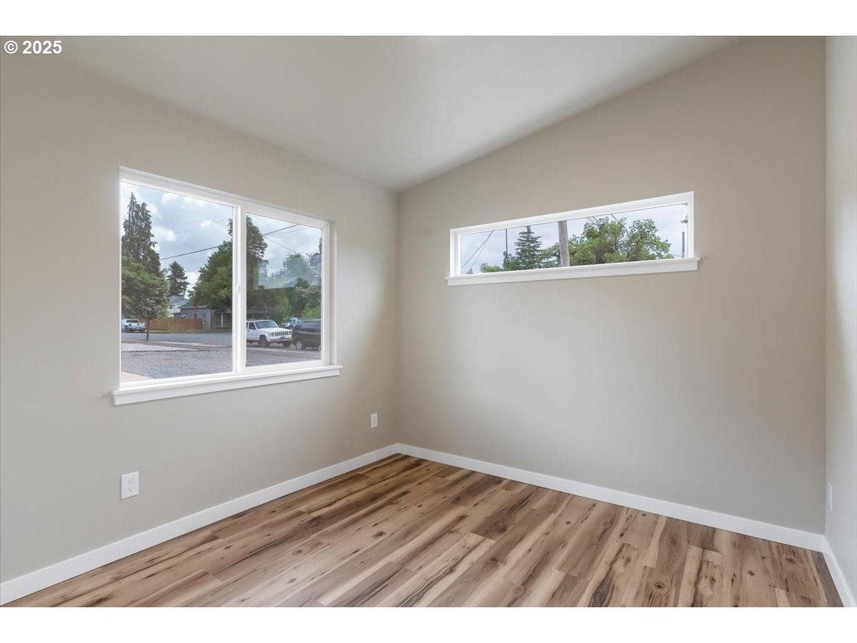 494 17th Street Northeast Salem, OR 97301 - Photo 42 of 44 an empty room with wooden floor and windows