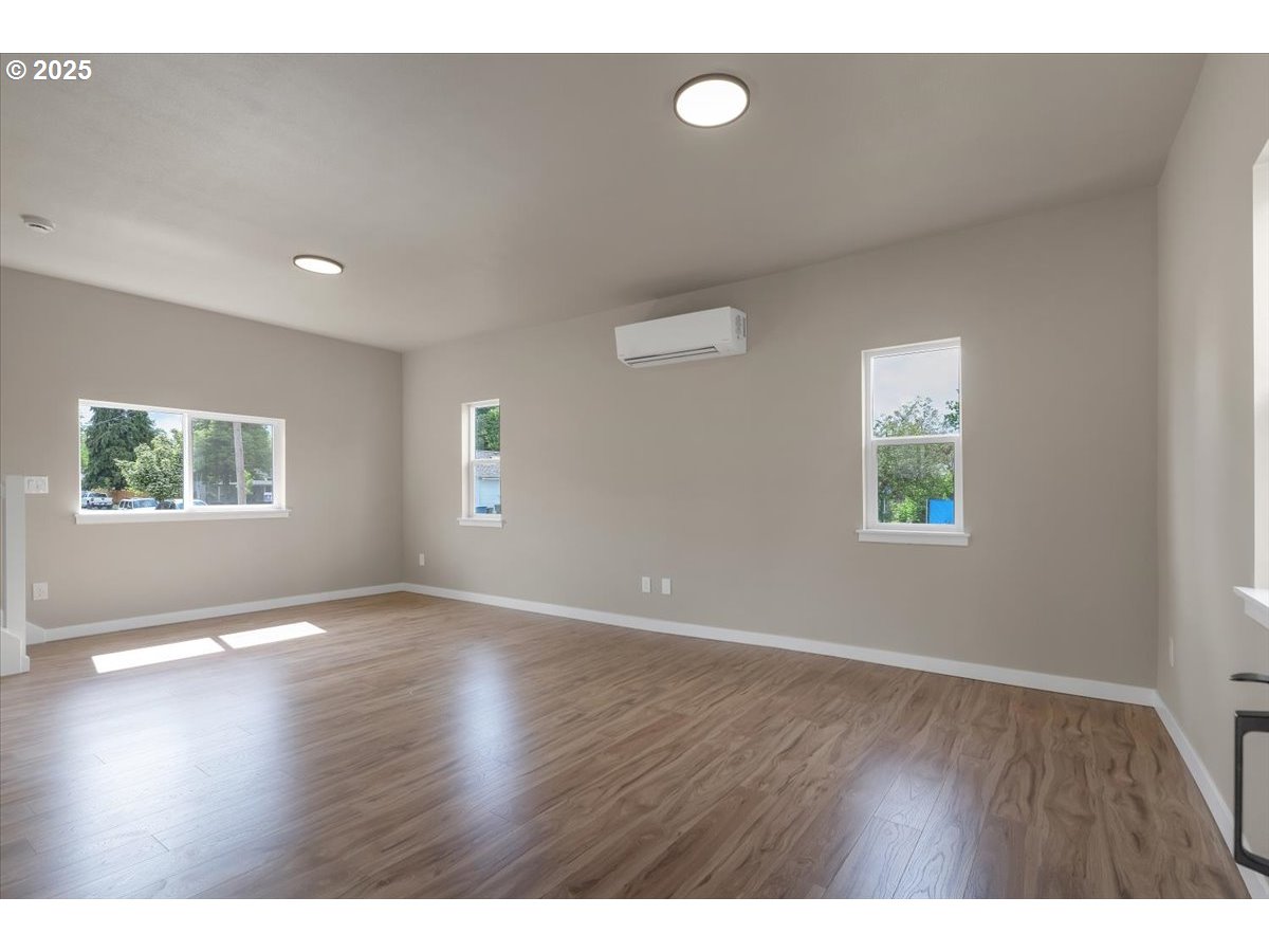 494 17th Street Northeast Salem, OR 97301 - Photo 8 of 44 a view of an empty room with wooden floor and a window