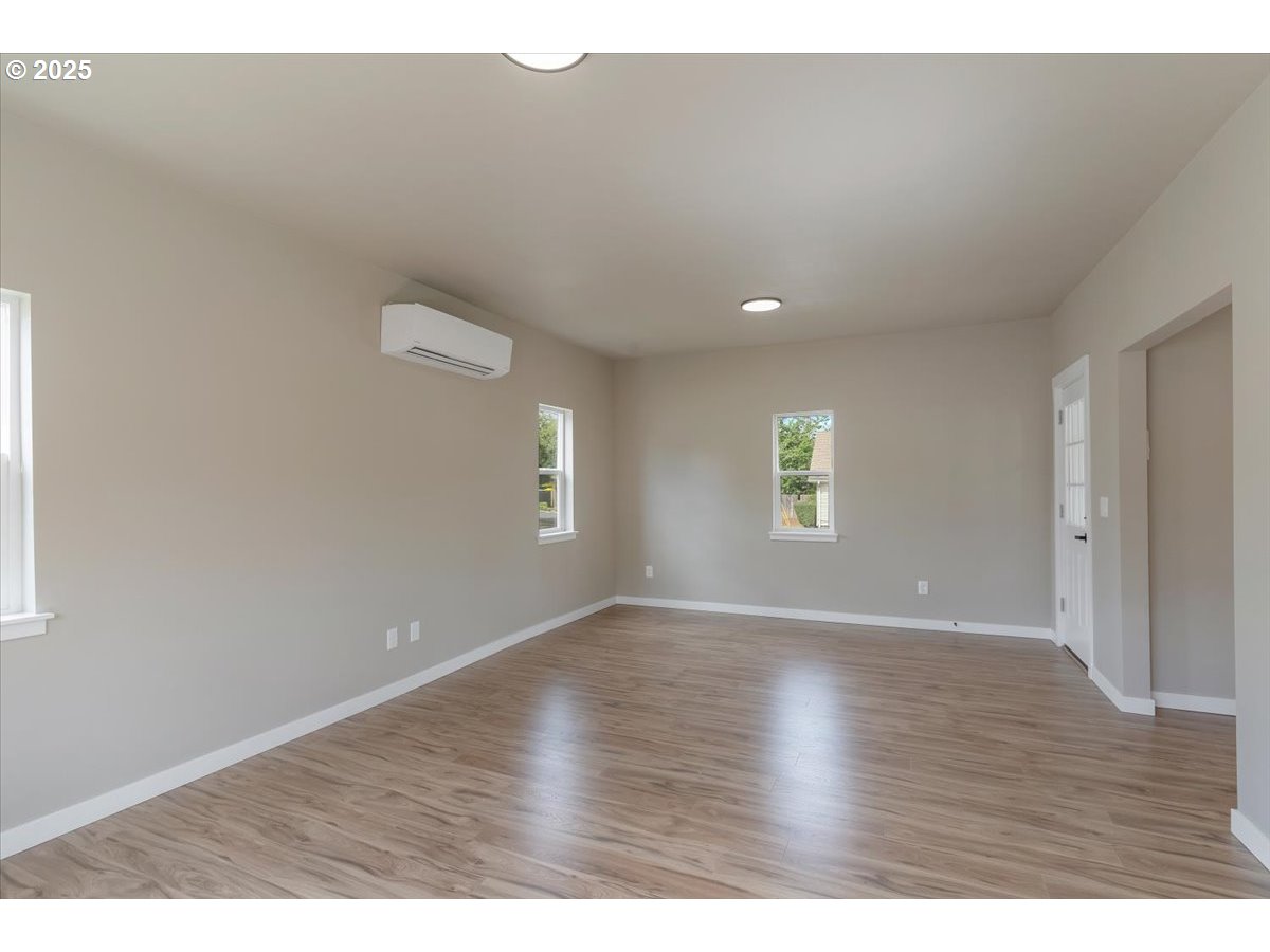 494 17th Street Northeast Salem, OR 97301 - Photo 9 of 44 an empty room with wooden floor and windows
