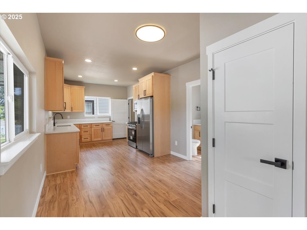494 17th Street Northeast Salem, OR 97301 - Photo 10 of 44 a open kitchen with white cabinets and stainless steel appliances