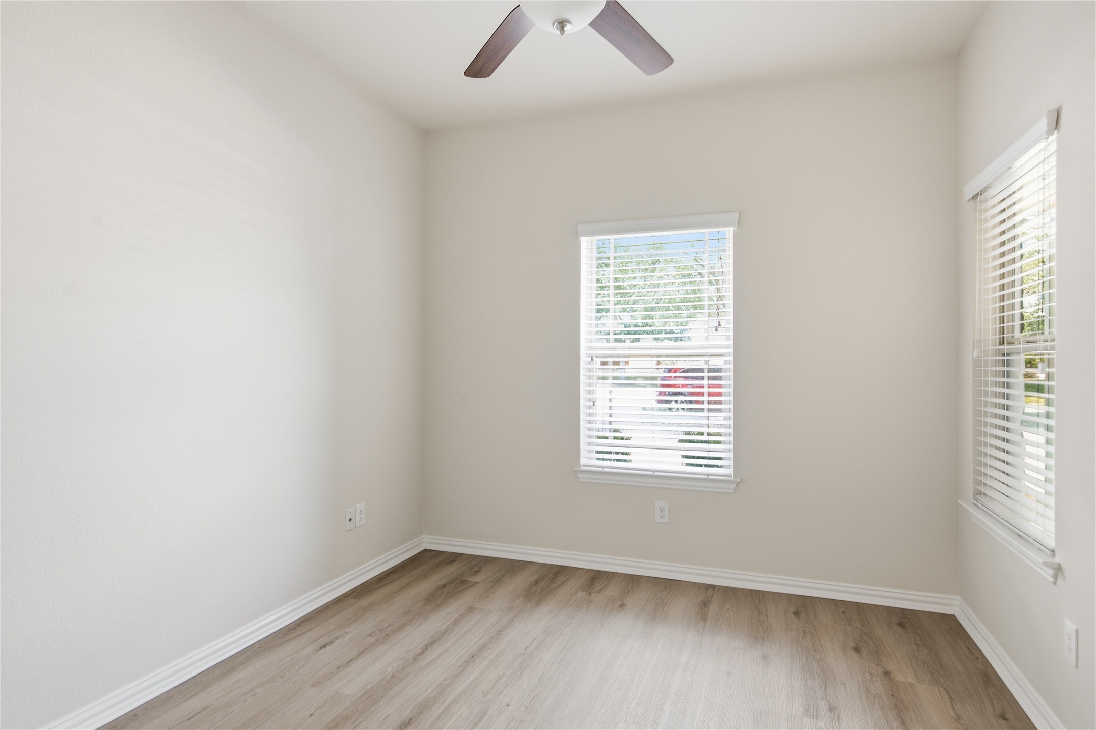 2601 Rough Berry Road Pflugerville, TX 78660 - Photo 24 of 36 A well-lit room featuring durable wood flooring and ample natural light from multiple windows.