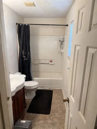 a bathroom with a toilet a sink and shower
