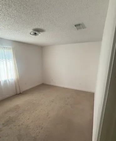 an empty room with a empty space and windows