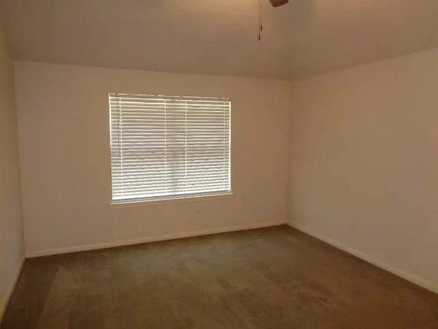 a view of a house with a small yard and wooden fence