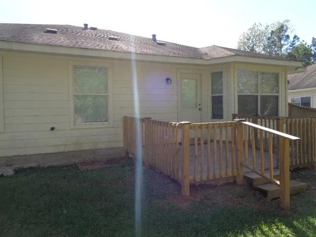 a view of a backyard with wooden fence