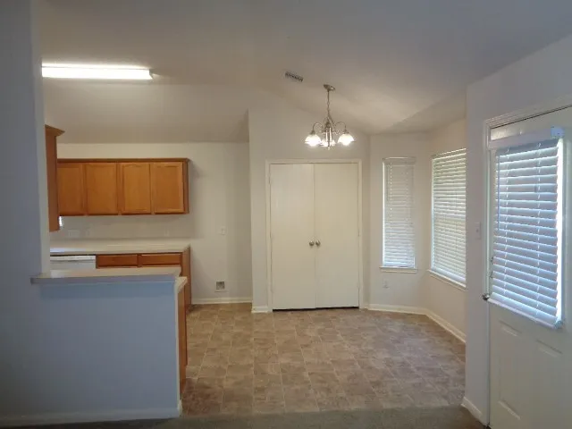 a kitchen with stainless steel appliances granite countertop a sink stove and cabinets
