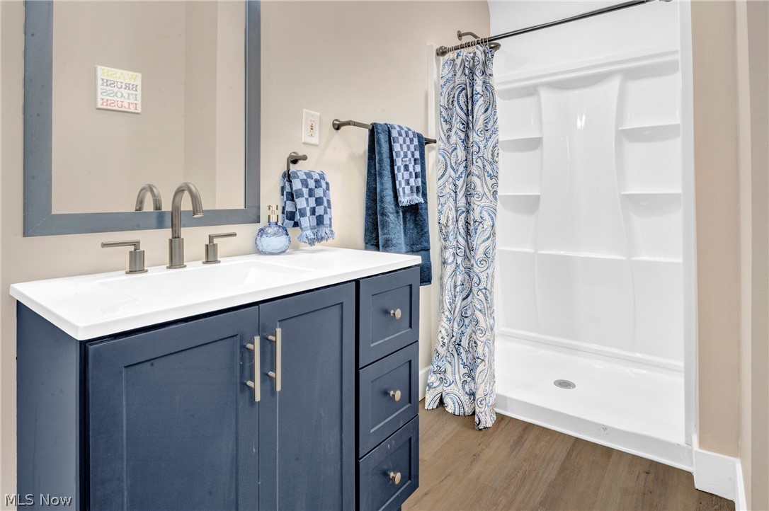 3218 Tullamore Road Cleveland, OH 44118 - Photo 25 of 42 Bathroom with LVP flooring walk in shower, and vanity