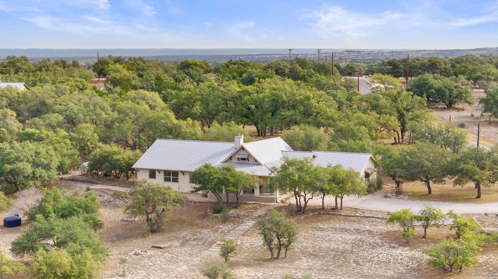 232 Crooked Oak Round Mountain, TX 78663 - Photo 2 of 40 an aerial view of a house with a yard and lake view